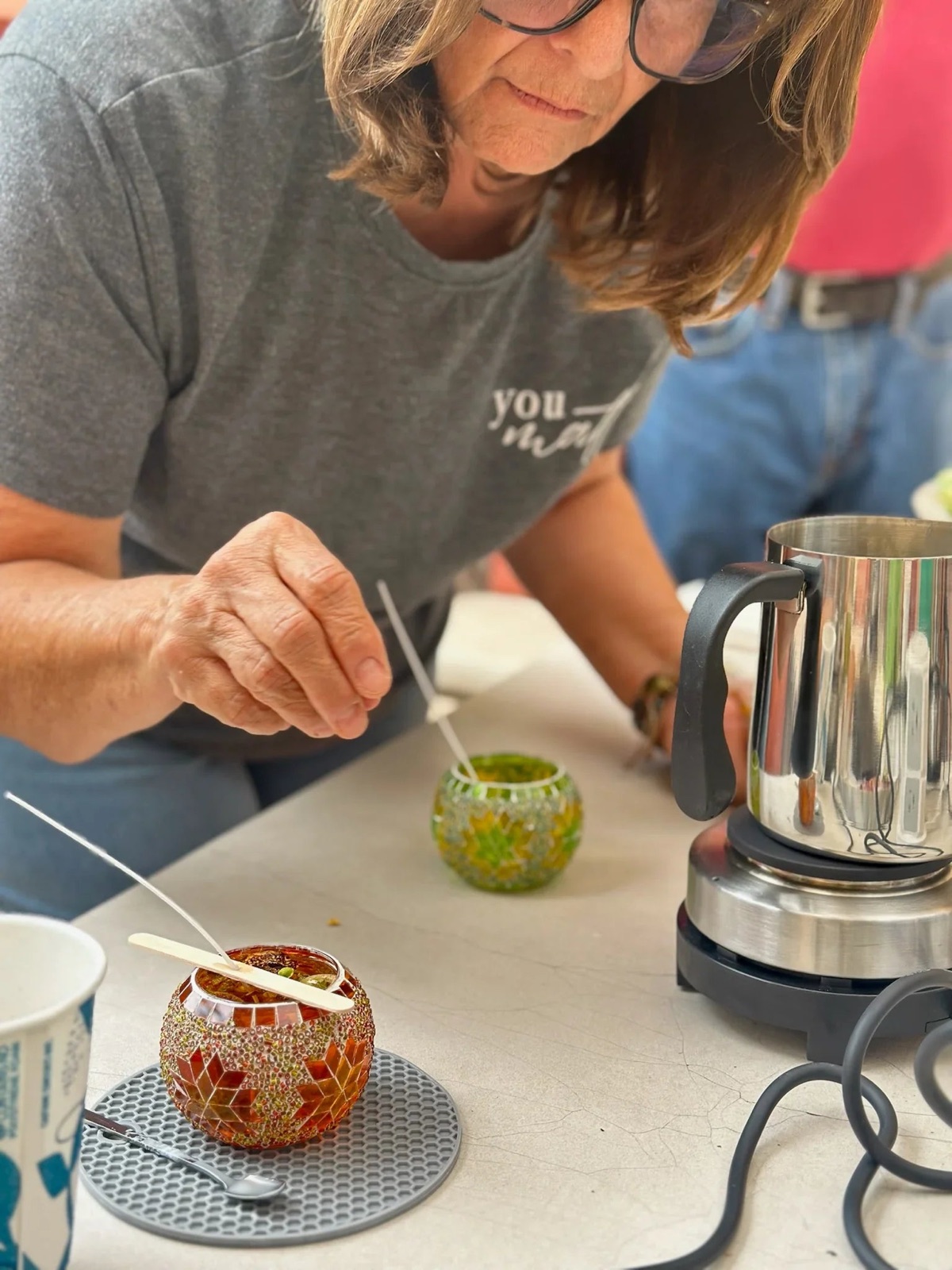 A guest wicking a candle