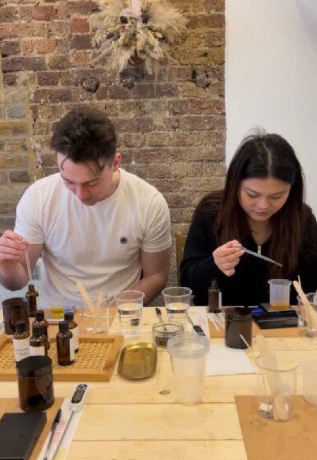 A couple making candles together